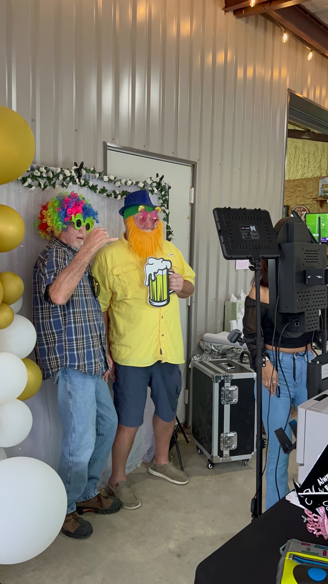 Guests posing with colorful photo booth props